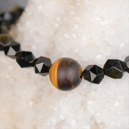 Discover the power of the Planet Legend Bracelet, featuring Matte Tiger&#39;s Eye and Golden Obsidian accent beads. This cosmic-inspired bracelet symbolizes protection, grounding, and the mysterious energy of the universe.