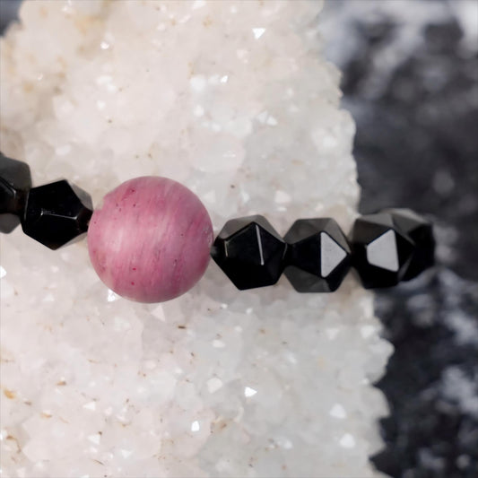 Discover the power of the cosmos with the Planet Legend Matte Rhodochrosite Bracelet, featuring 12mm matte Rhodochrosite beads paired with Golden Obsidian.