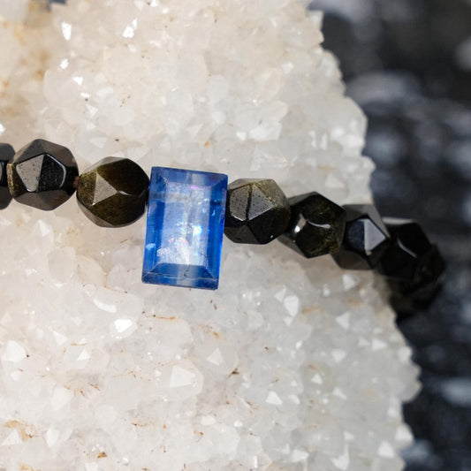 Step into the vastness of the universe with the Cosmic Gate Bracelet, featuring a stunning combination of Kyanite and Golden Obsidian. Designed to channel the protective energies of the cosmos, it enhances spiritual awareness, and protection.