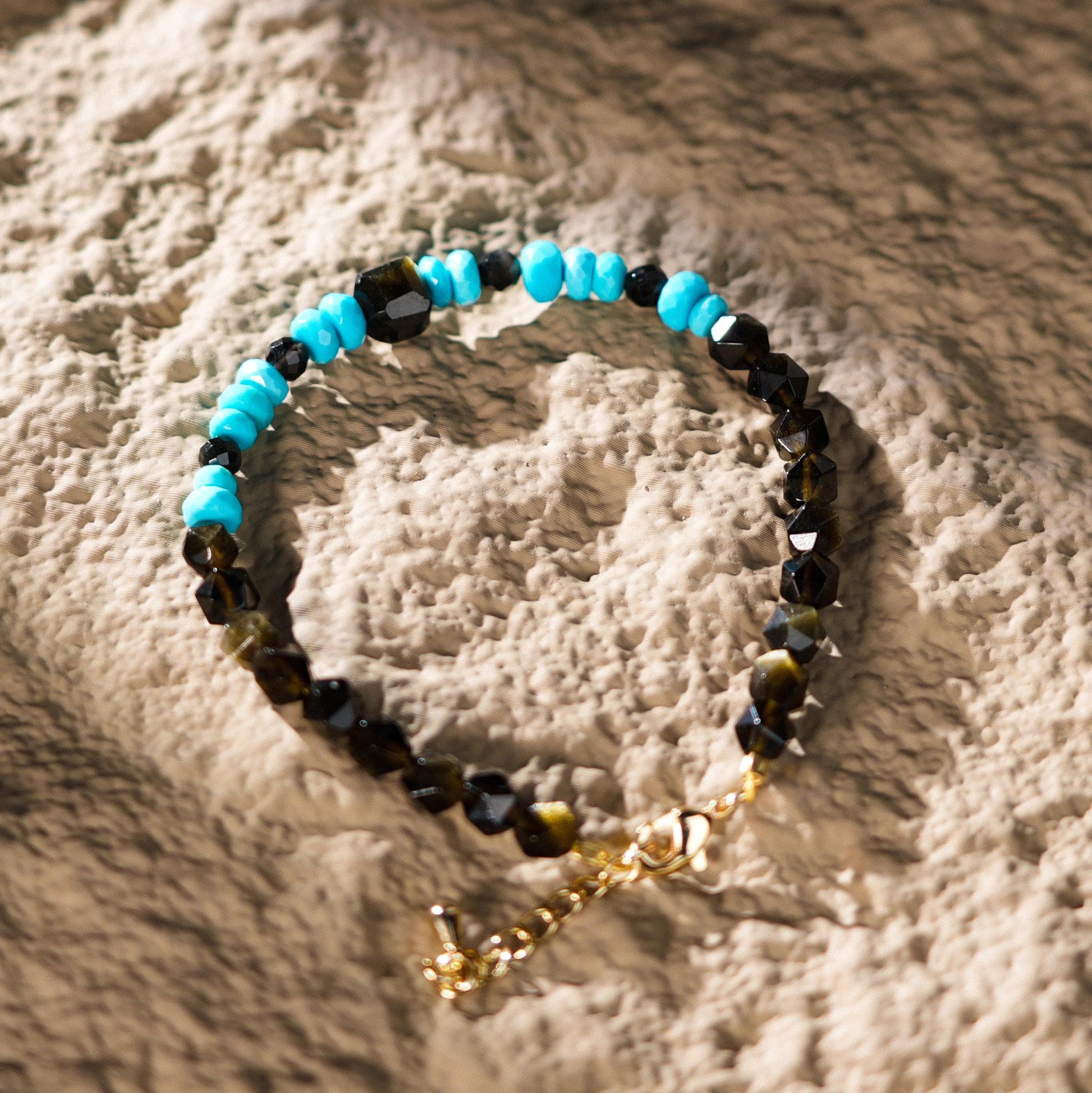 This beautiful bracelet features Sleeping Beauty Turquoise, a stone known for its connection to spiritual dreams and emotional healing, paired with Golden Obsidian, renowned for its grounding and protective properties.