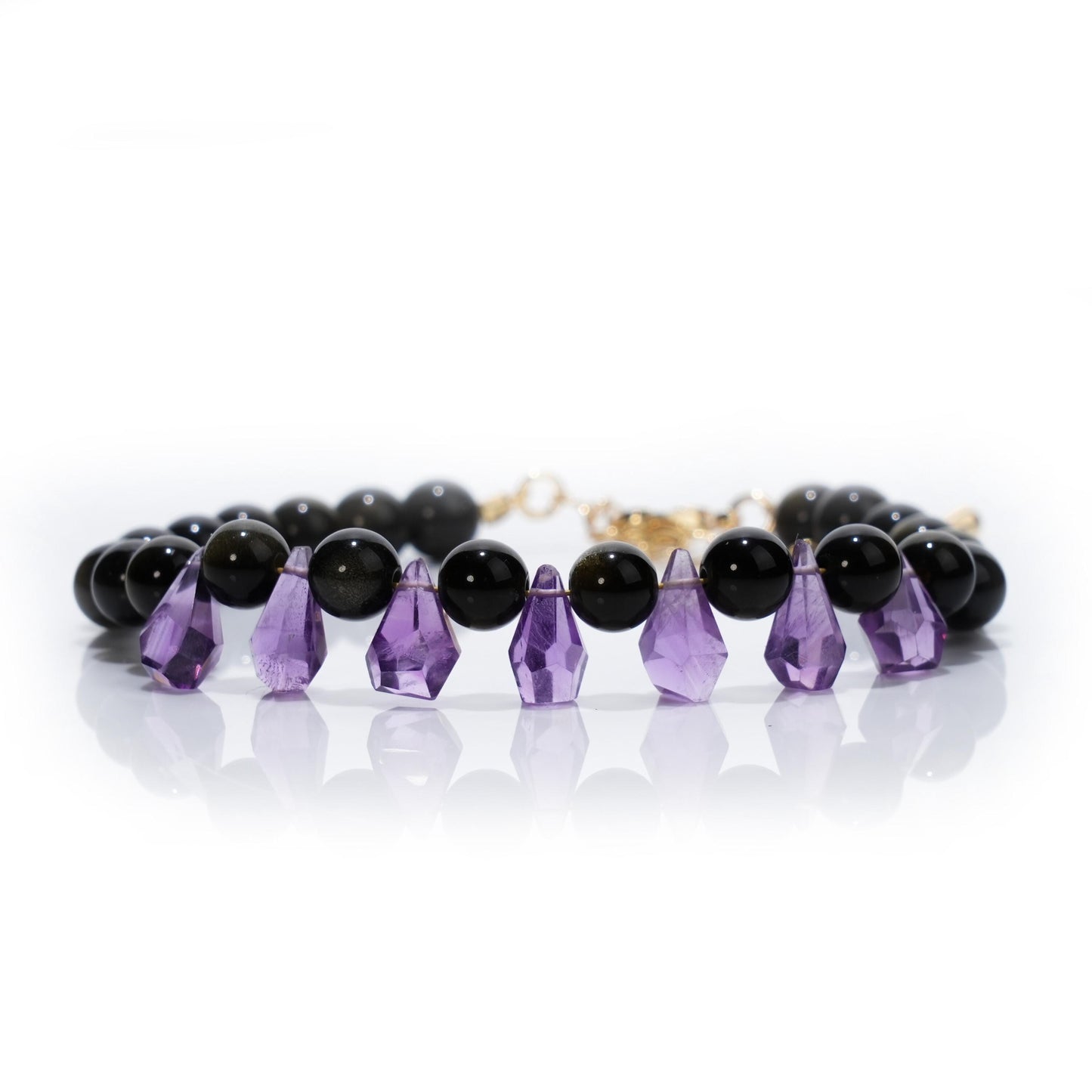 Tara&#39;s Star Amethyst Waterdrop Bracelet featuring Golden Obsidian, symbolizing spiritual healing, protection, and cosmic energy. A unique crystal jewelry piece from Purple Planet, perfect for meditation and personal growth.