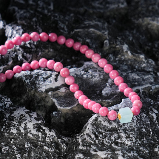 This beautifully crafted necklace features Rhodonite, a stone known for emotional healing and balance, paired with serene Aquamarine, which promotes peace and calmness.