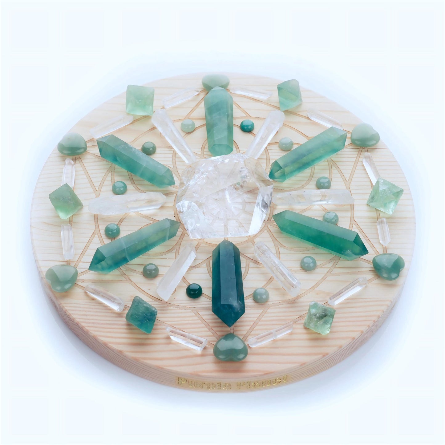 Featuring a harmonious arrangement of Green Fluorite, Green Aventurine, and Clear Quartz on a 9.8-inch Sacred Geometry pinewood grid with a 2cm thickness, this set is designed to channel powerful energies for growth, abundance, and inner clarity.