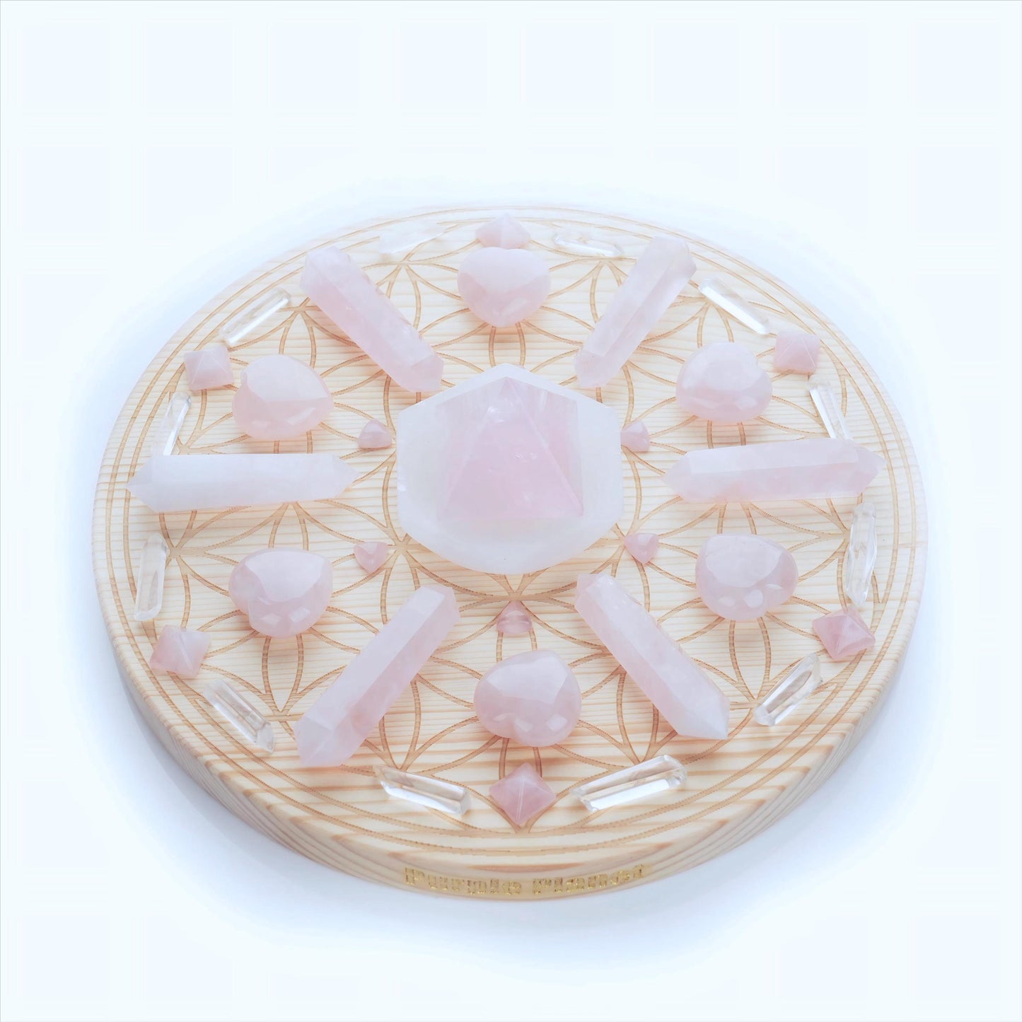 This Crystal Grid set is arranged on a 9.8-inch Flower of Life Sacred Geometry pinewood grid, bringing the energy of love and balance. Featuring Rose Quartz, Selenite, and Clear Quartz, it’s designed to create love, compassion, and inner peace.