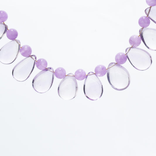 This beautiful necklace features a teardrop-shaped Lavender Amethyst stone, known for promoting emotional balance and spiritual calmness, paired with matching round Lavender Amethyst beads.